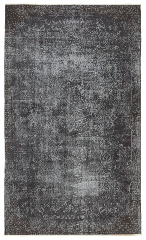 Full overhead view of the charcoal geometric vintage area rug on a white background