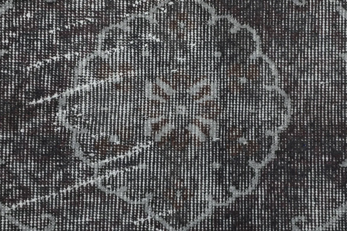Close-up of the low pile and hand-knotted wool texture, revealing subtle color variations