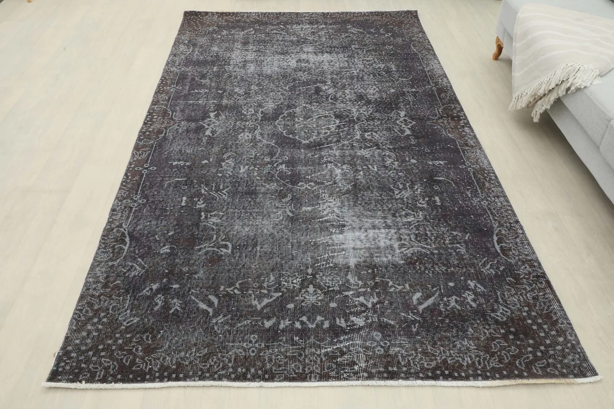 Full overhead view of the charcoal rug in a room setting, emphasizing its overall shape and design