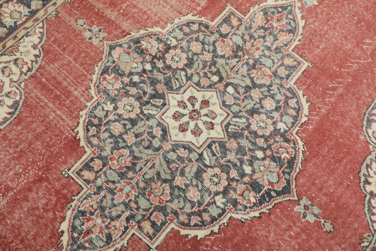 Detailed view of the central navy and ivory medallion with intricate floral patterns.