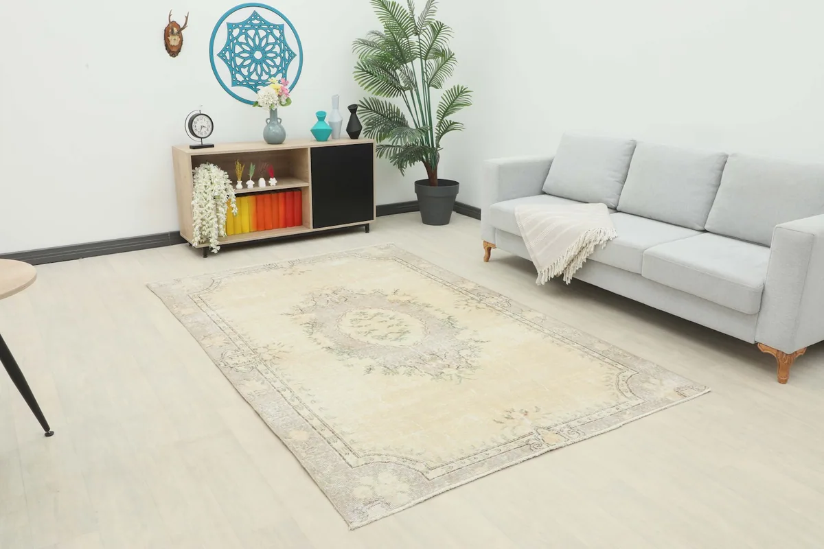 Ivory and gray vintage rug placed in a modern living room setting