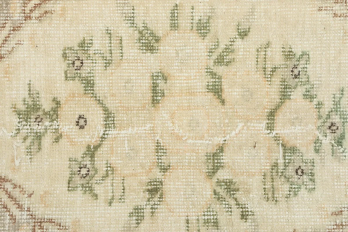Close-up of a floral motif and the low pile texture on the rug
