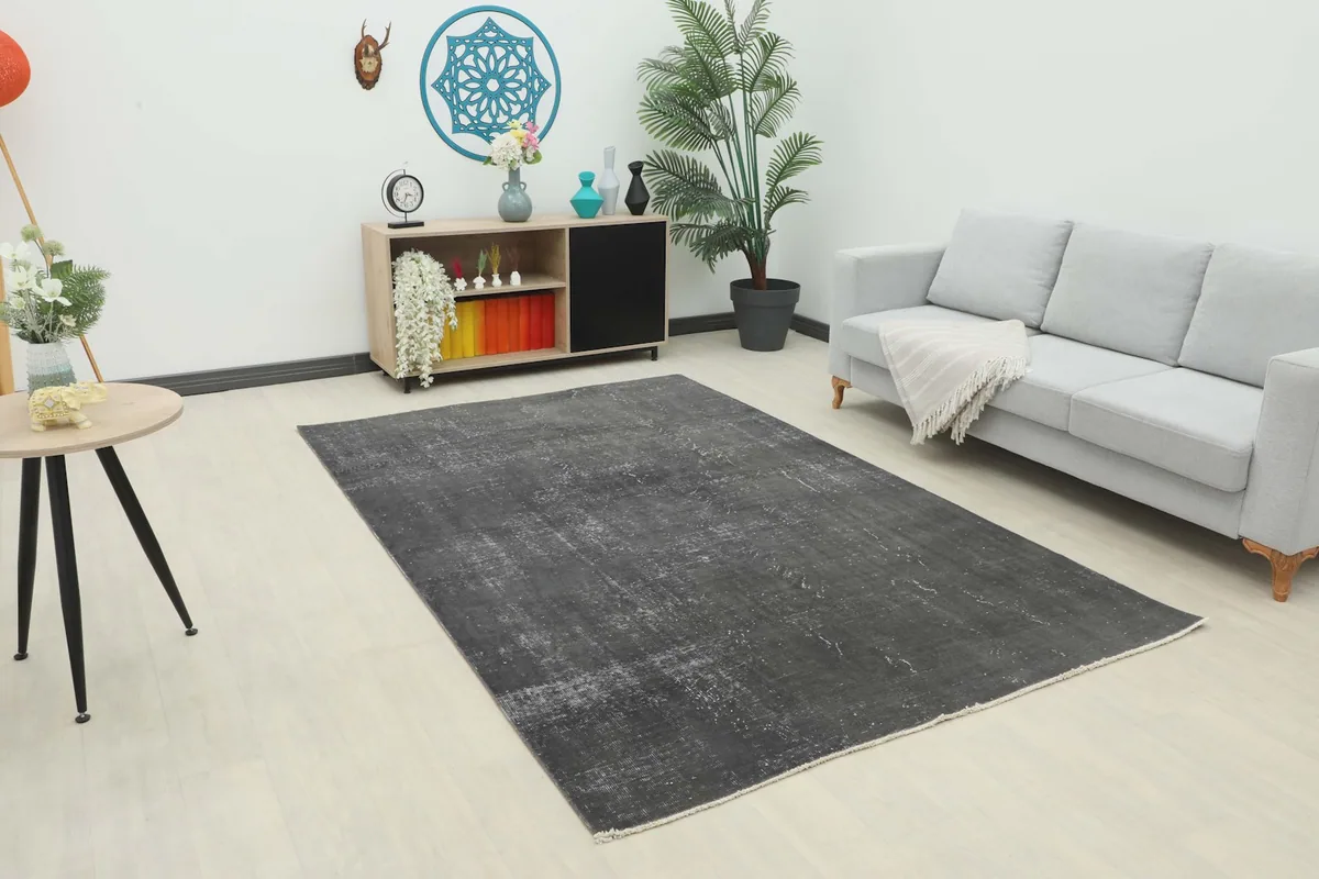 Charcoal vintage area rug in a modern living room setting with a light gray couch