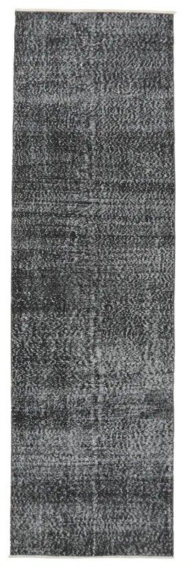 Full overhead view of the charcoal and gray vintage runner rug on a white background.