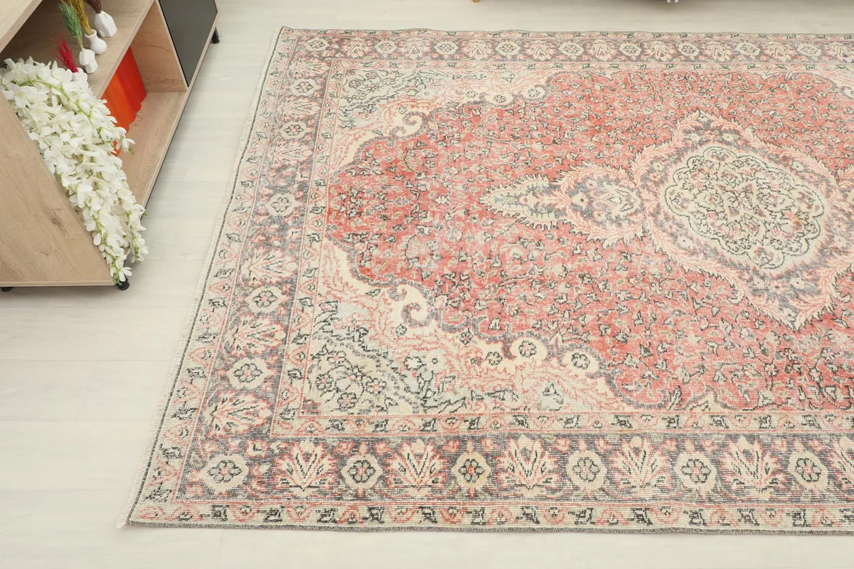Close-up angle view of the lower left section of the rug, showing design details and color variations.