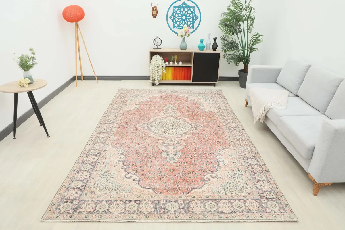 Full room shot of the large rust medallion rug, illustrating its impact on the decor.