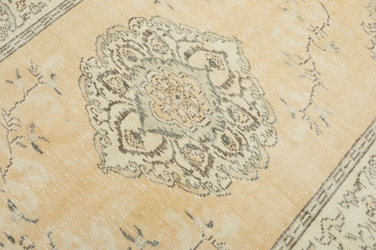 Close-up detail of the central medallion of the Beige Medallion Anatolian Rug, showing intricate gray patterns.
