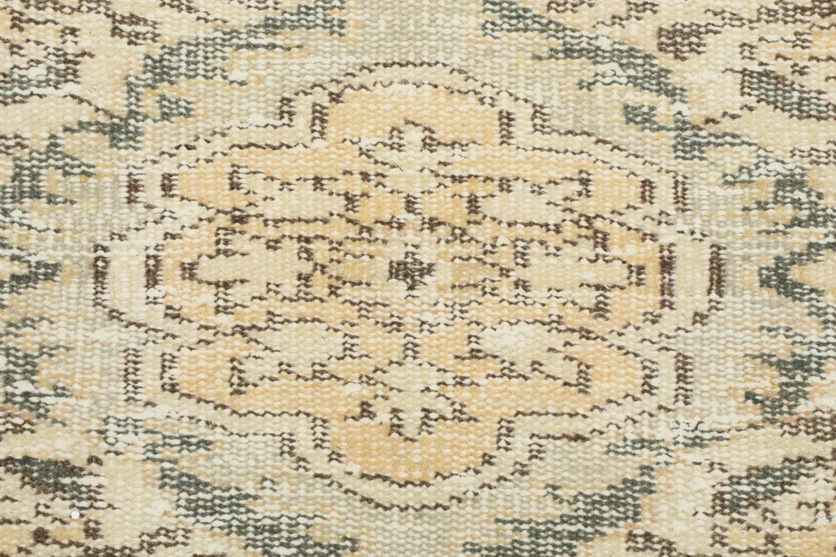 Close-up of the low wool pile of the Beige Medallion Anatolian Rug, revealing the hand-knotted texture and faded colors.