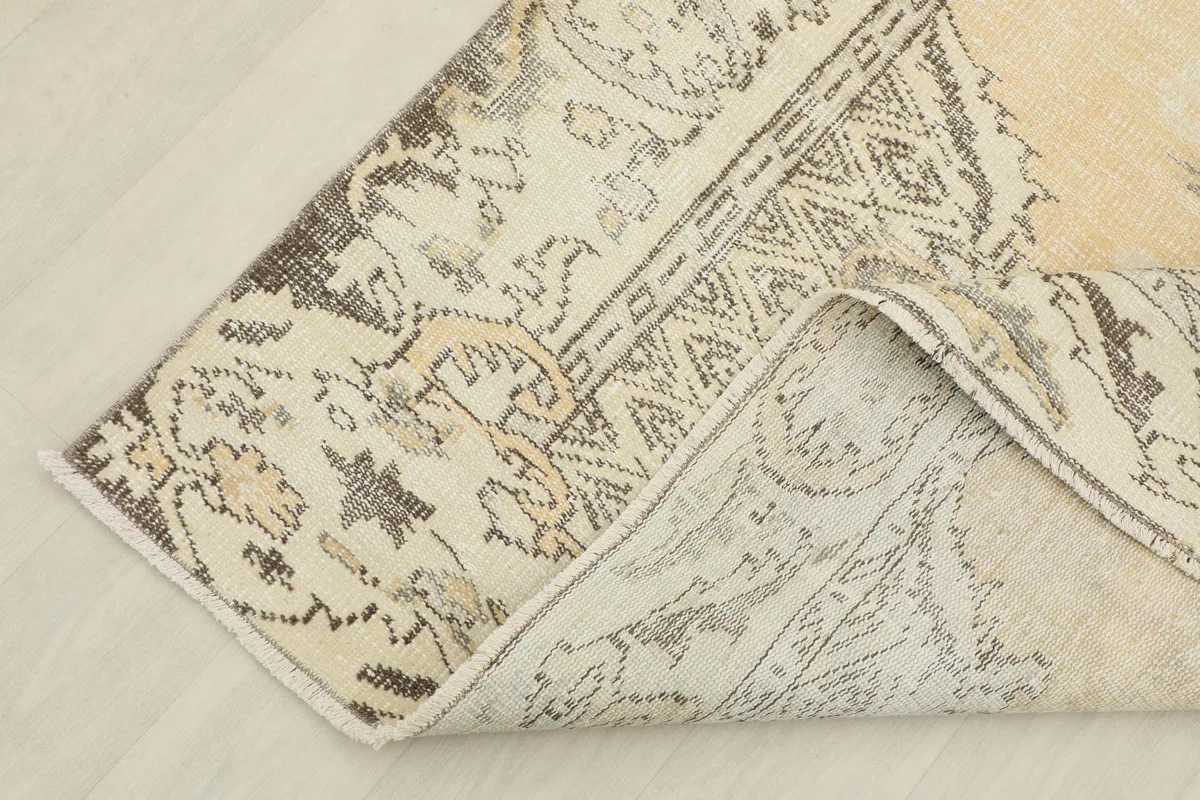 Another view of the corner of the Beige Medallion Anatolian Rug, showing the hand-knotted construction from the back.