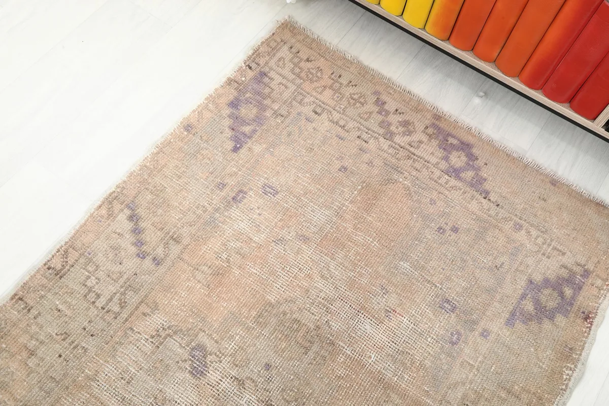 Corner view of the runner rug, highlighting the blend of beige and purple tones