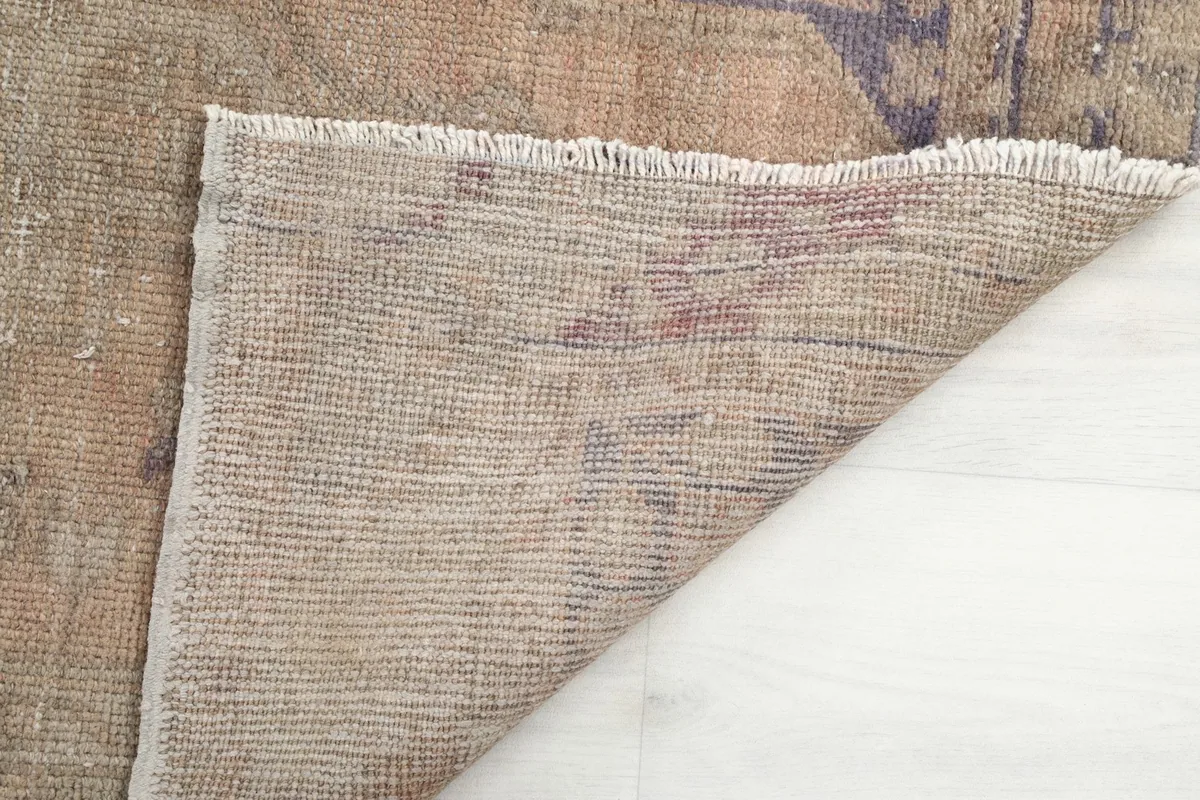 Close-up of the reverse side of the rug, showing the intricate knotting and cotton foundation