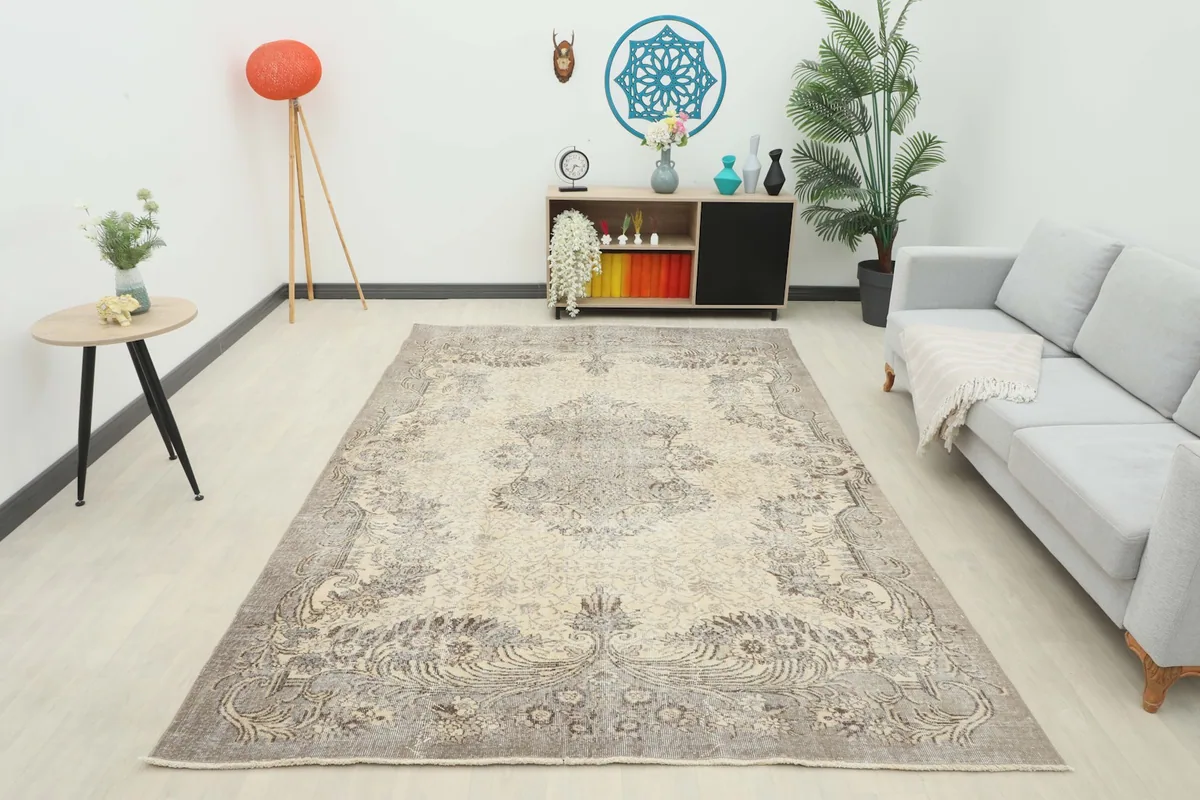 Full room view of the ivory and charcoal vintage rug, showcasing its overall presence and design.