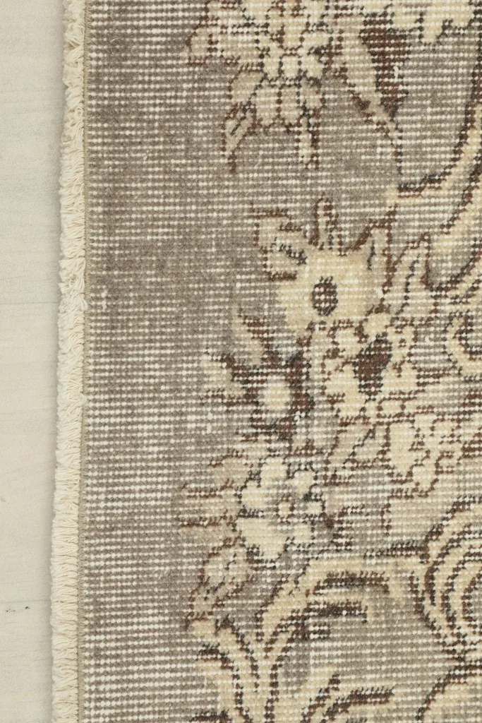 Close-up of the charcoal border and fringe, revealing the subtle color variations and hand-knotted edge.