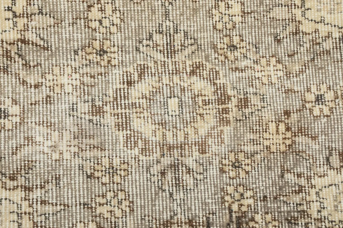 Detail showing the low wool pile and hand-knotted texture of the vintage Anatolian rug, with visible wear.