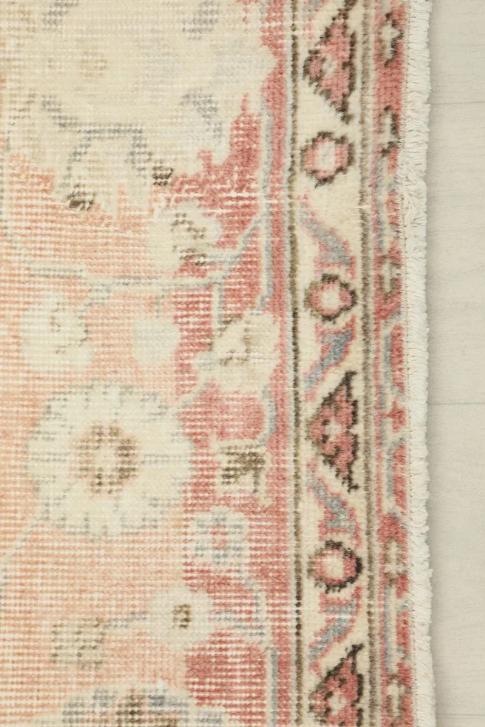 Close-up of the rose outer border with geometric and floral elements, showing edge detail