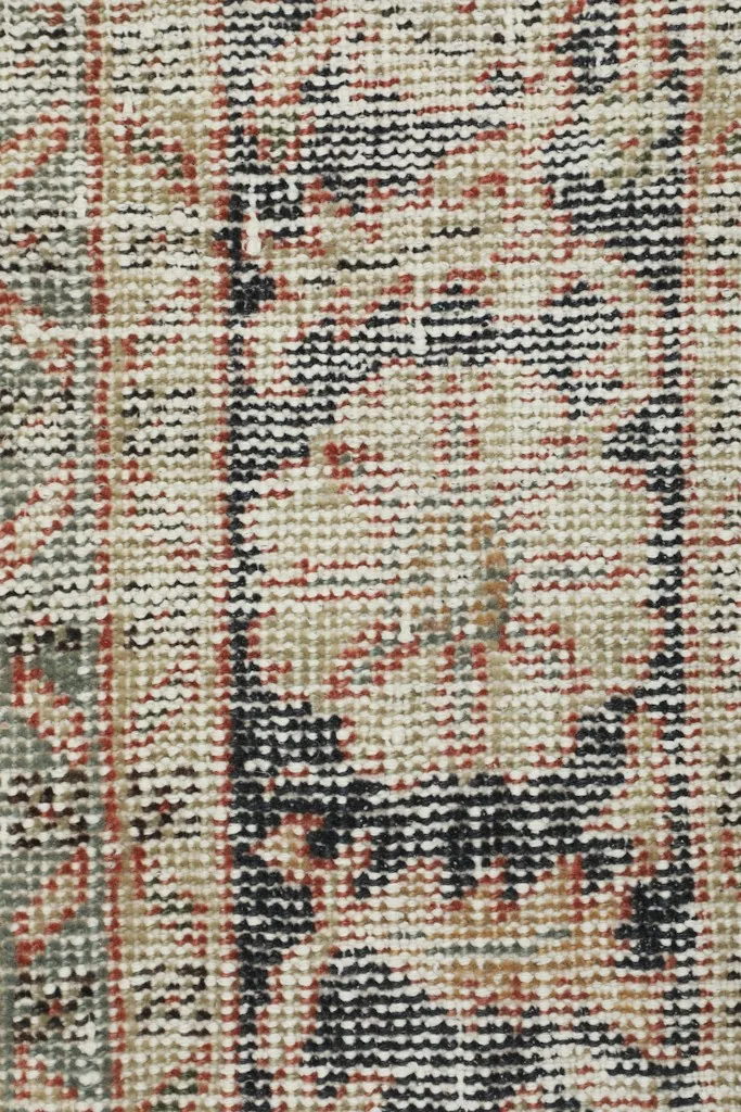 Extreme close-up of the rug's fibers and weave, displaying the hand-knotted detail and color variation.