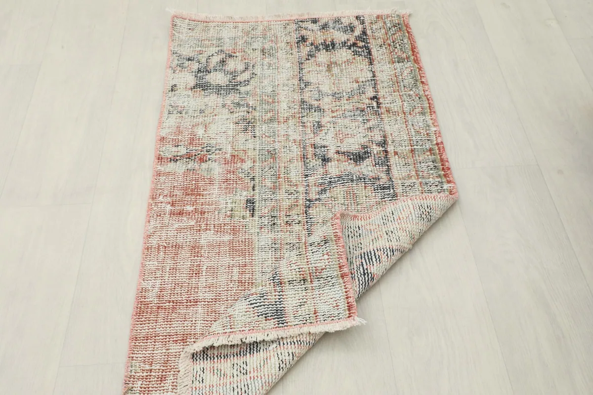 The rug partially folded, illustrating its flexibility and the consistent pattern from different angles.