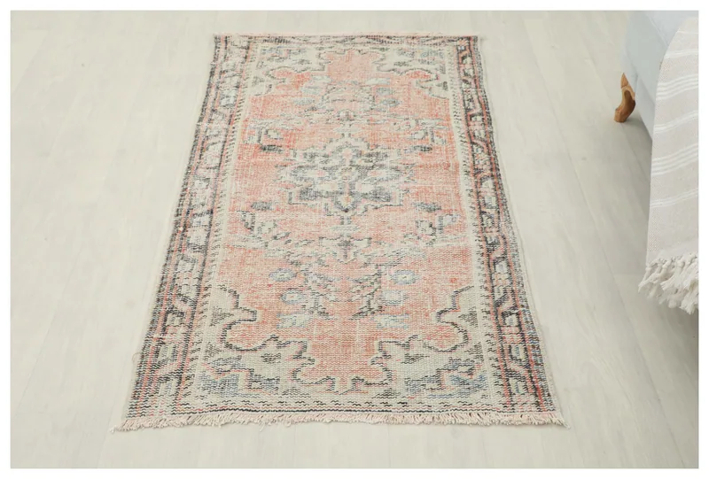 Full top view of the 2'7" x 4'8" orange and gray vintage Anatolian rug on a white background.
