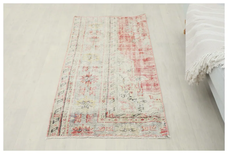 Full overhead view of the 2'4" x 4'11" vintage Anatolian area rug with cream and rose tones