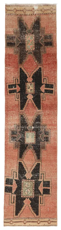 Full overhead view of the 2'7" x 11'9" vintage Anatolian runner rug with rose and black geometric patterns.
