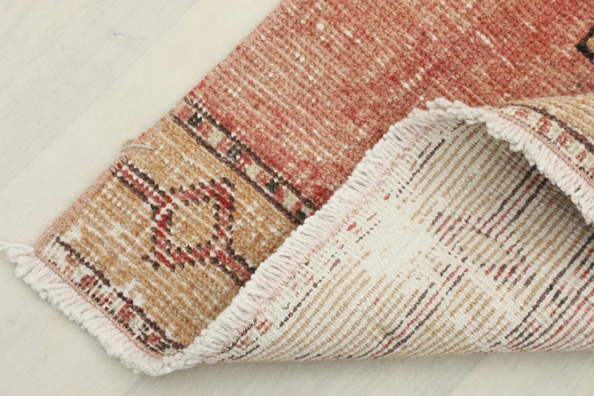 View of the back of the hand-knotted runner, showing the cotton foundation and tight weave.