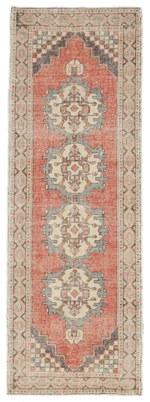 Full top view of the vintage rust geometric medallion runner on a white background