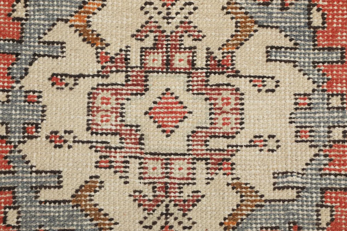 Very close view of the intricate hand-knotted details within a geometric motif