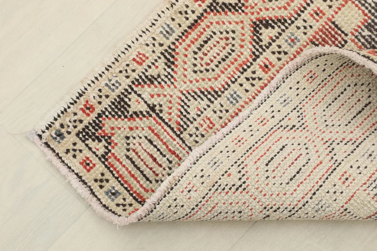 Close-up of the back of the hand-knotted wool runner, showing cotton foundation