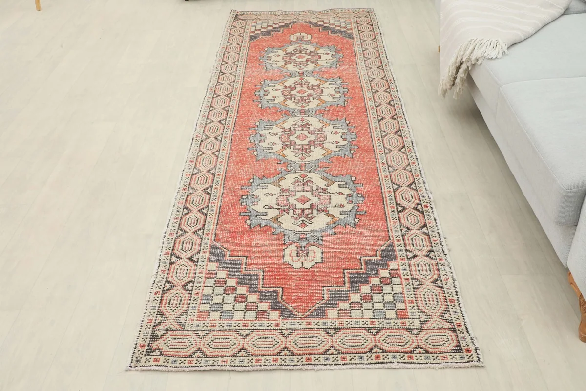 Full overhead view of the rust geometric runner laid out in a room