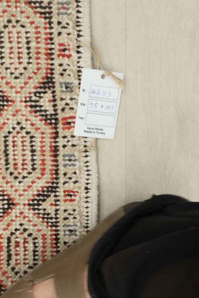 Rug tag showing size and origin on the back of the hand-knotted runner