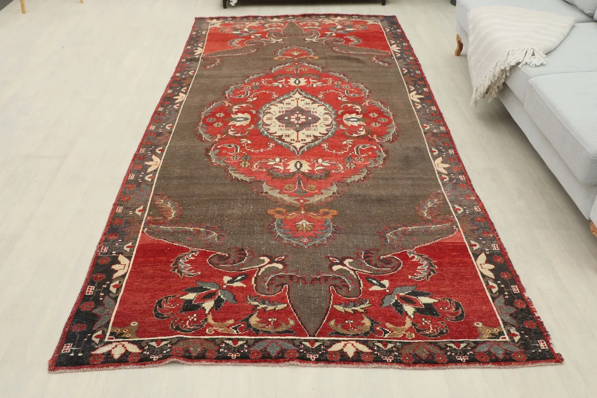 Full room view of the gray and red vintage rug, showcasing its overall presence