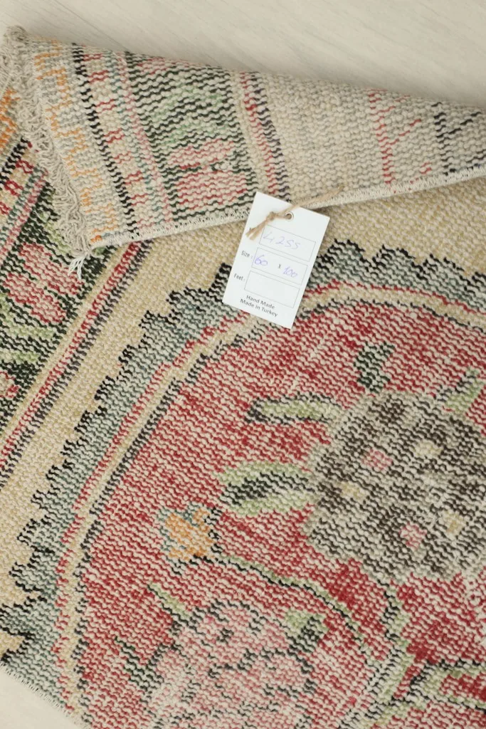 Close-up of the rug's label attached to the back, indicating its origin and materials.