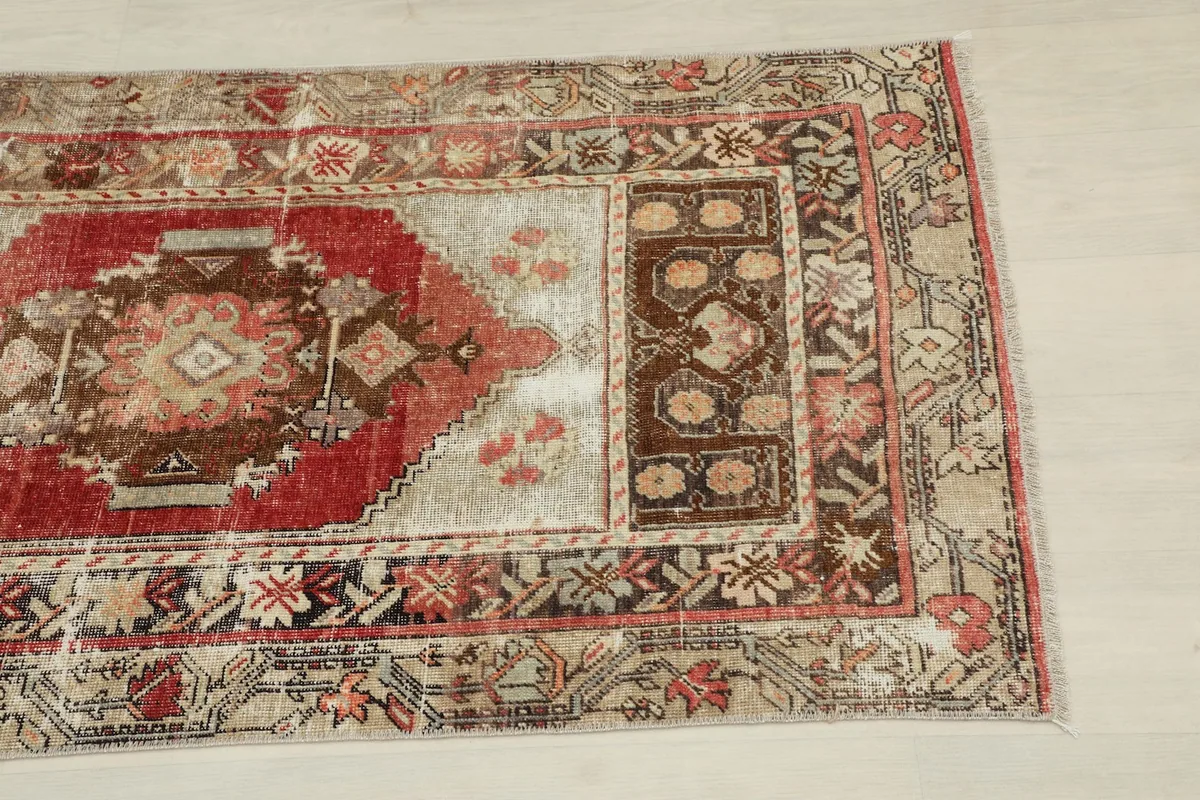 Close-up of the upper right section of the rug, showing geometric motifs and color variations