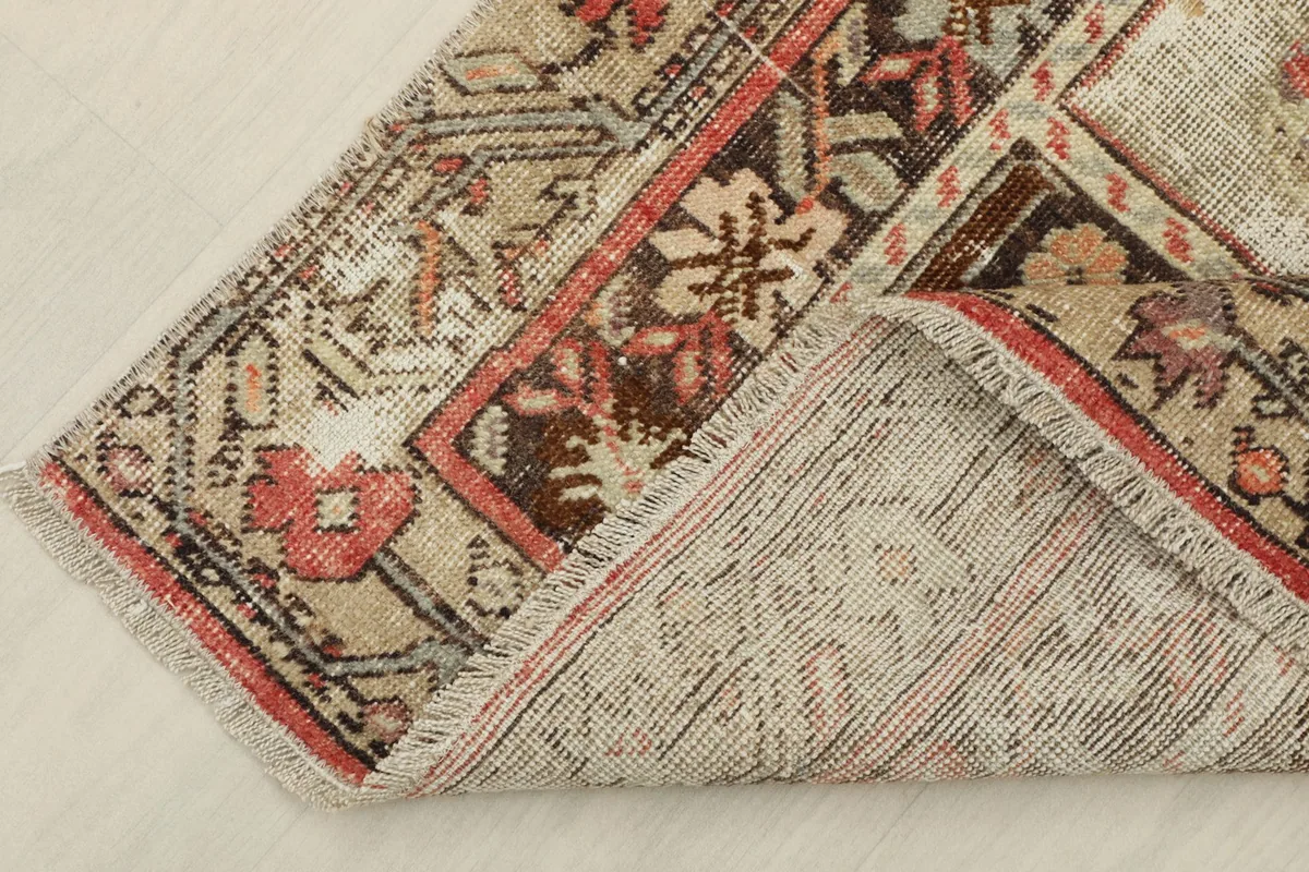 View of the rug's underside, revealing the cotton foundation and hand-knotted construction