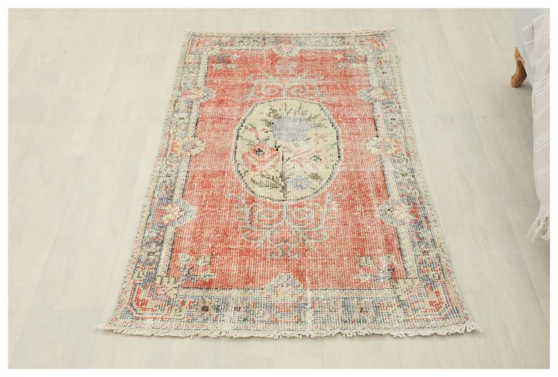 Full top view of the 2'6" x 4'8" rust Anatolian floral medallion rug on a white background
