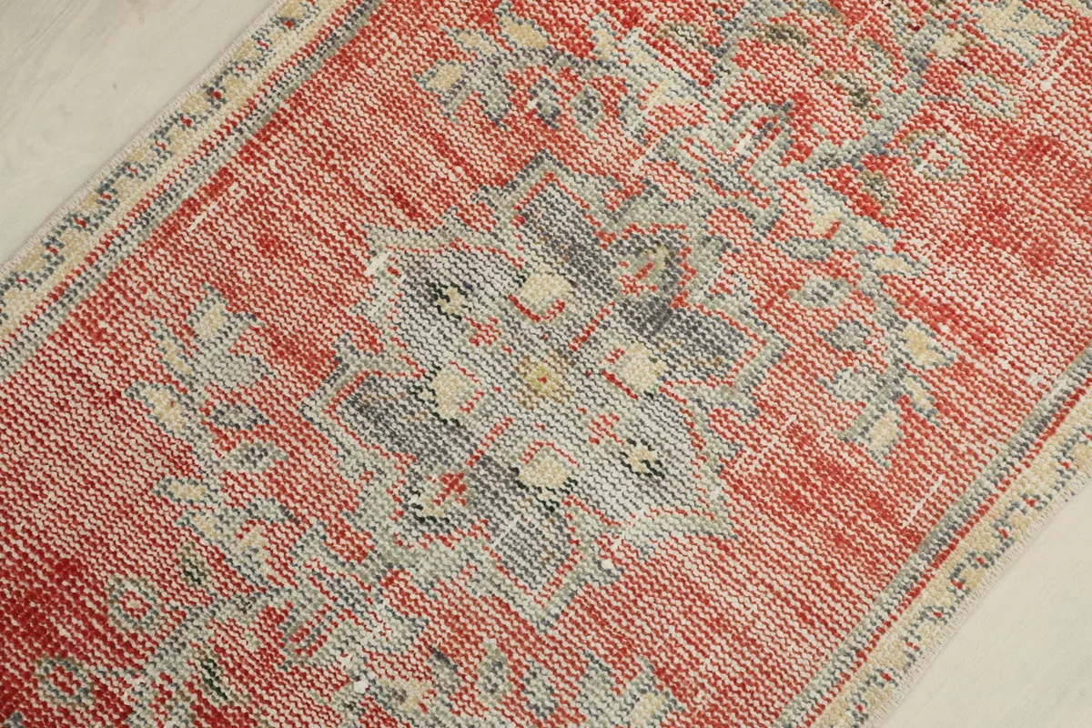 Detailed view of the central geometric medallion, showcasing the gray, blue, and ivory tones.