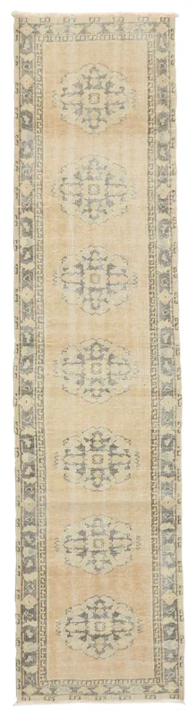 Full top view of the beige and gray geometric Anatolian runner rug on a white background