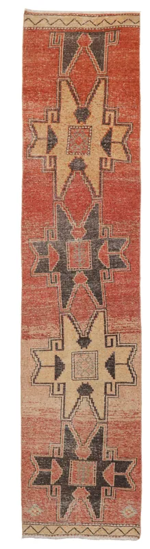 Full overhead view of the rust, tan, and charcoal geometric Anatolian runner rug on a white background.