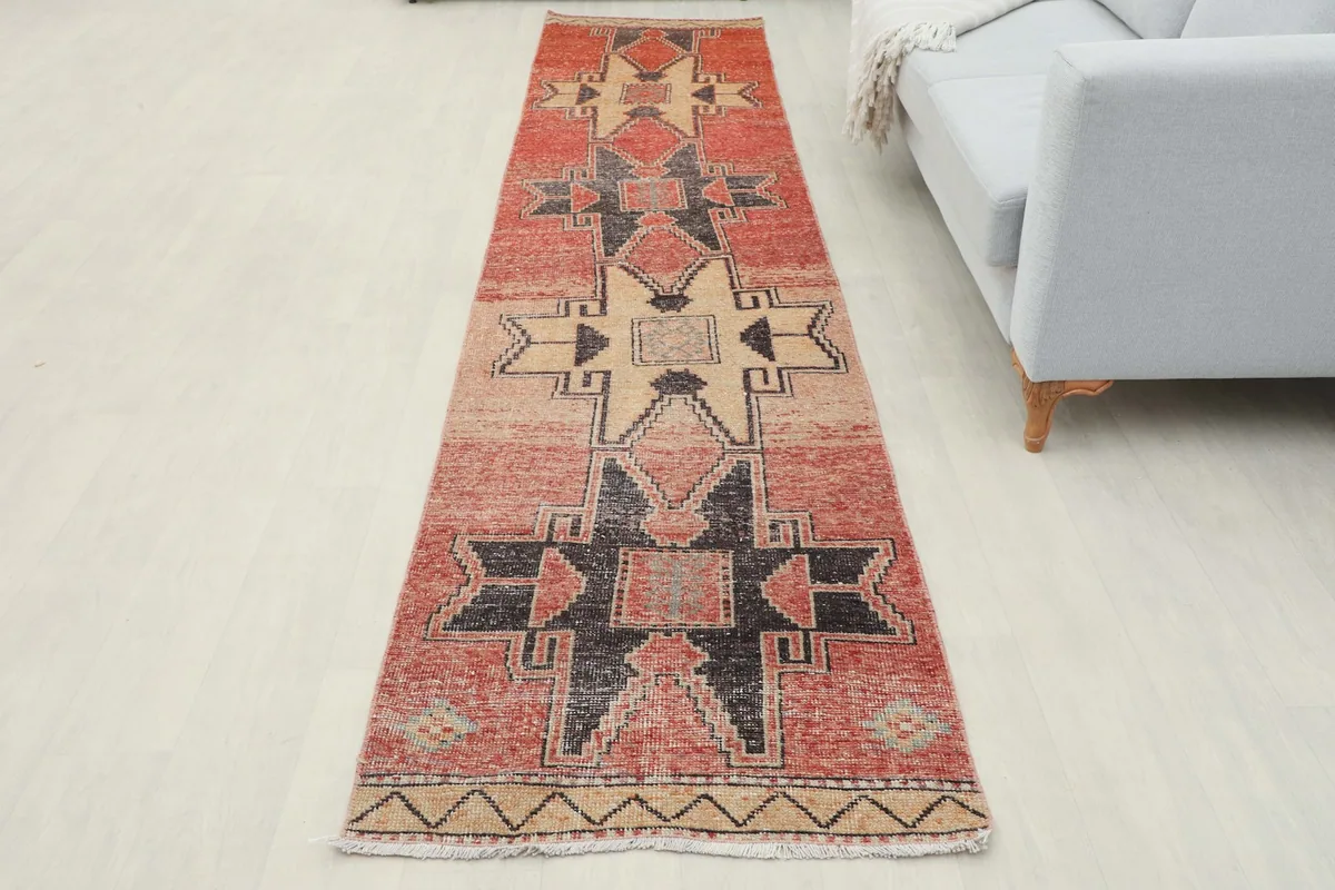 Full overhead view of the runner rug in a room setting, displaying its complete geometric design.