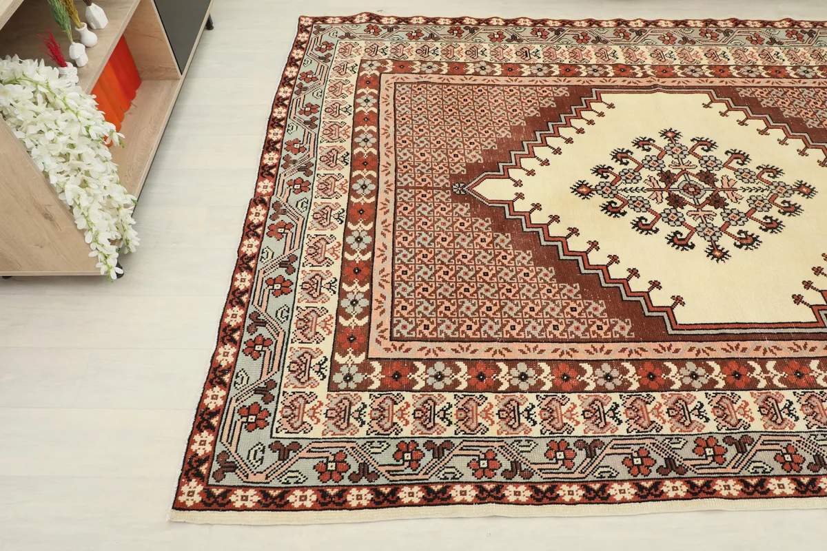 Detailed angle shot of the rug, highlighting the central ivory medallion and surrounding field.