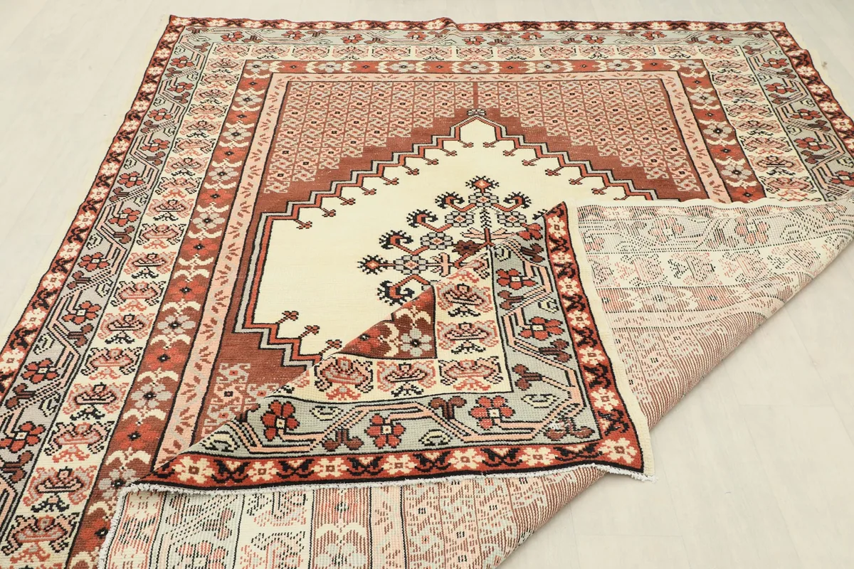 View of the rug's underside, revealing the cotton foundation and hand-knotted construction.