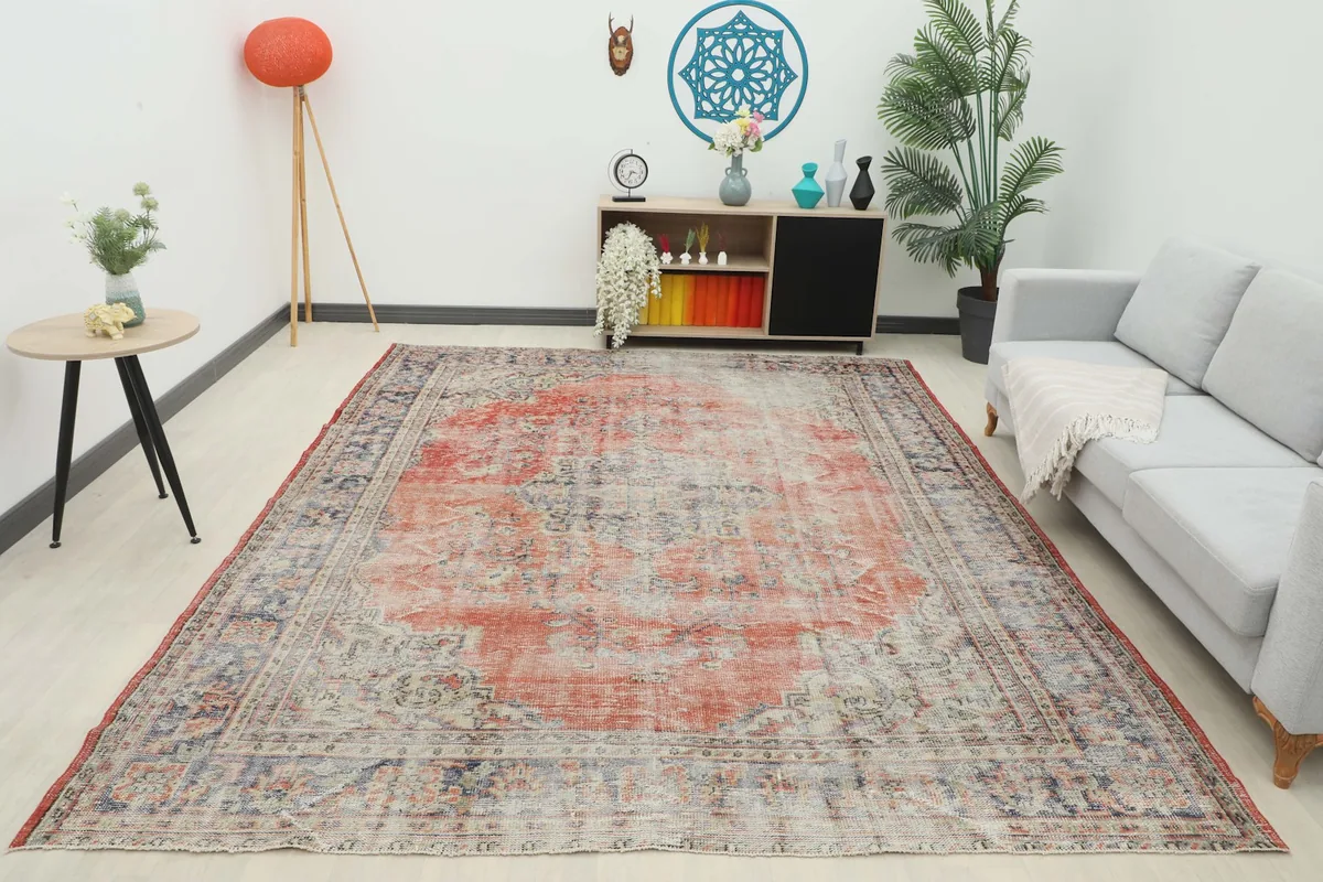 Full overhead view of the rust and navy vintage area rug in a modern living room setup.