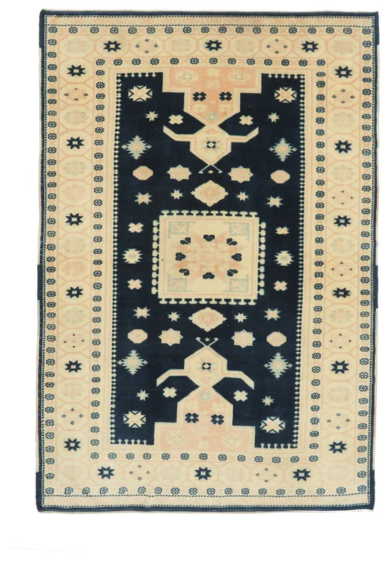 Full overhead view of the navy and beige geometric Anatolian rug on a white background