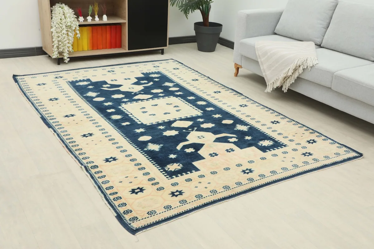 Angled view of the navy and beige rug on a light floor in a contemporary room