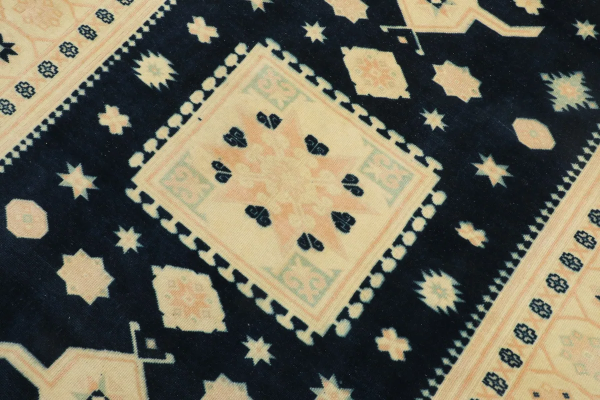 Detailed view of the central beige medallion with rose and navy motifs