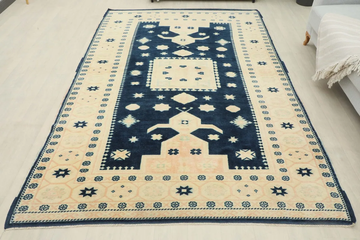 Full overhead view of the navy and beige vintage rug in a room setting