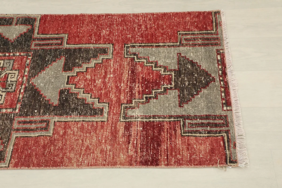Close-up view of the lower geometric pattern and red field, highlighting color variations