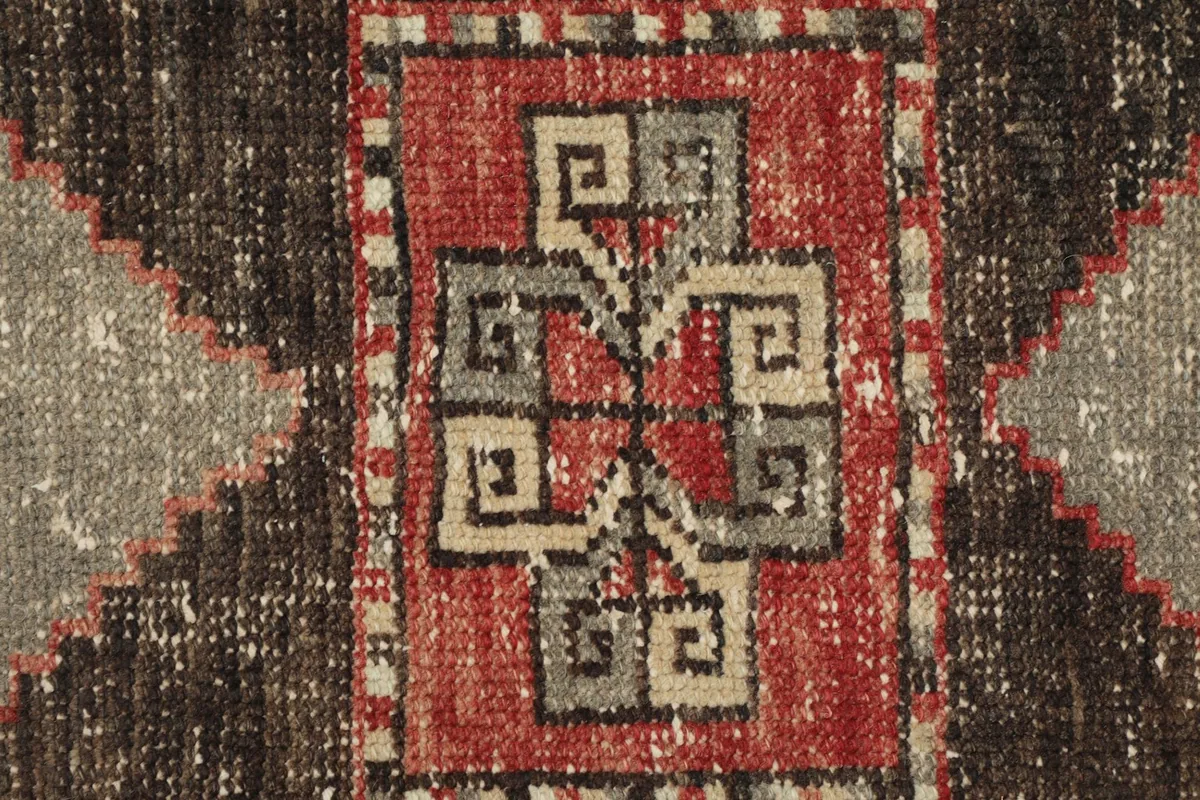 Extreme close-up of the intricate central motif within the medallion, showing knot detail
