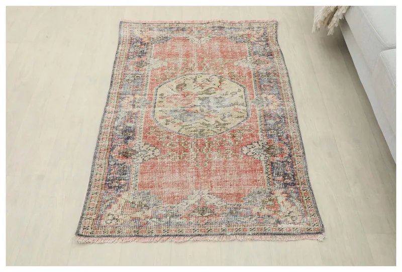 Full overhead view of the vintage Anatolian rug with rose field and navy border