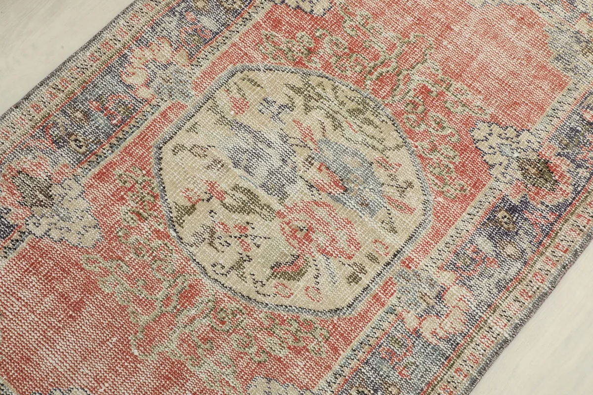 Detailed view of the central beige medallion with floral and geometric motifs